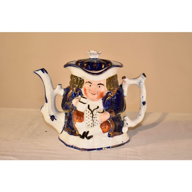 19th century Toby tea pot from the Staffordshire region of England. The top is in a scalloped shape and is a brilliant...