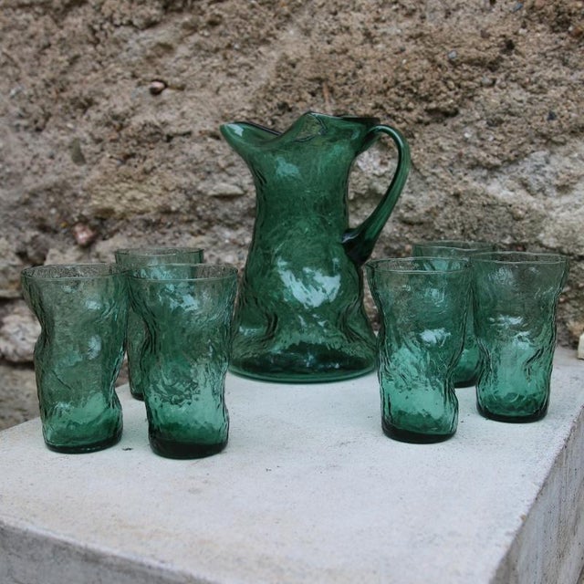Vintage orangeade service in emerald green blown glass. retro charm. consisting of a pitcher and six matching glasses,...
