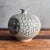 Korean Buncheong-style stoneware moon jar form vase. Wheel-thrown with hand-incised allover cloud scroll ground and...