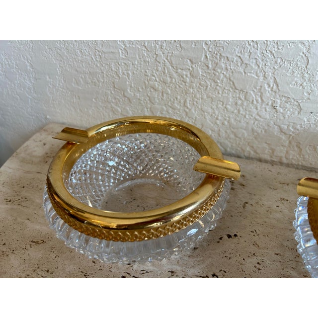 Striking pair of vintage ashtrays with cut crystal bowl and gilt brass necks in trays.