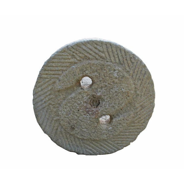 This top of a watermill stone was retrieved from the northern part of China. It was originally used for grinding grains....