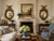 A rare matched pair of large Federal-style convex mirrors, each crowned by a finely modeled spread-wing eagle above an...