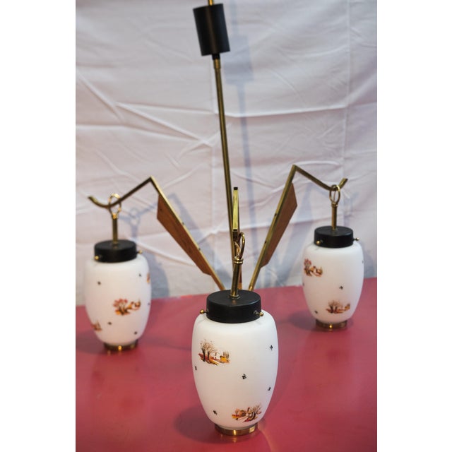 Vase-shaped pendant lamp with three shades in opaline and satin white glass with hand-painted landscape decorations, in...