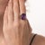 This striking vintage amethyst ring is a colorful 1970’s design, centered by an emerald cut amethyst weighing...