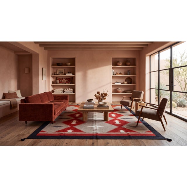 Elevate high-end interiors with this hand-woven Navajo-inspired wool flat-weave rug. Featuring striking serrated diamond...