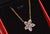 This elegant natural pink sapphire and diamond floral necklace is crafted in solid 18K yellow gold. The timeless floral...