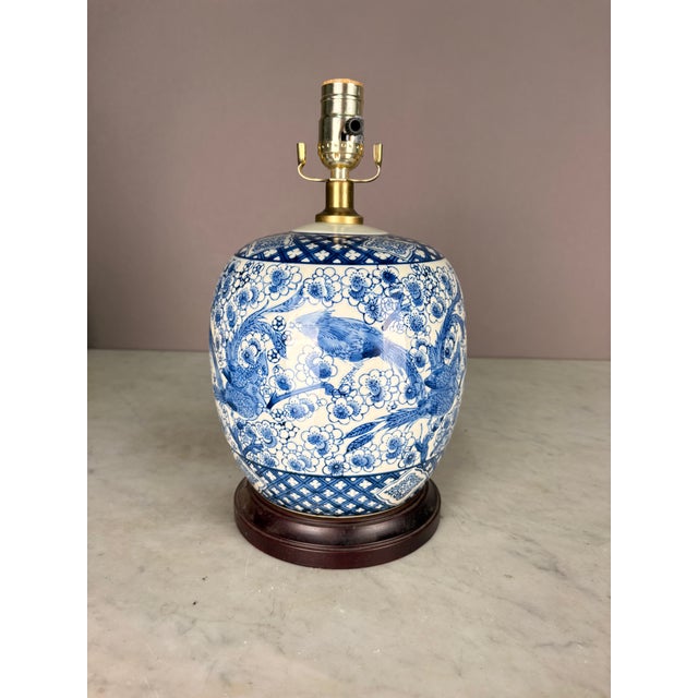 Patterned porcelain lamp of birds and florals, and clover motif. Wooden Base. Working condition corded electric.