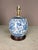 Patterned porcelain lamp of birds and florals, and clover motif. Wooden Base. Working condition corded electric.