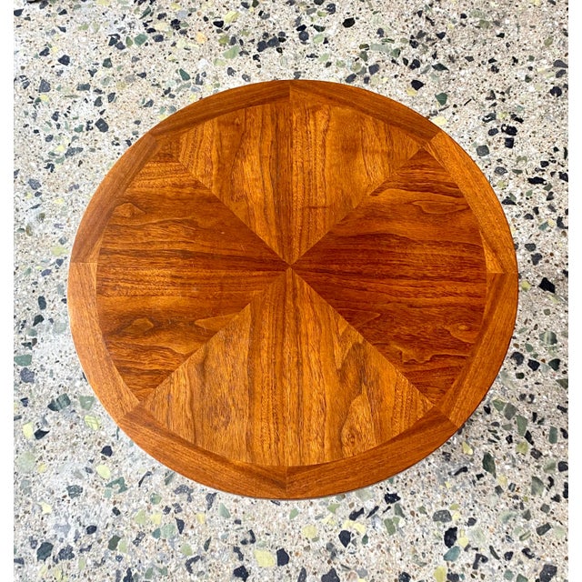 A beautifully scaled side table from the Rhythm Collection by Lane Furniture. The round top has mirror quadrant walnut...