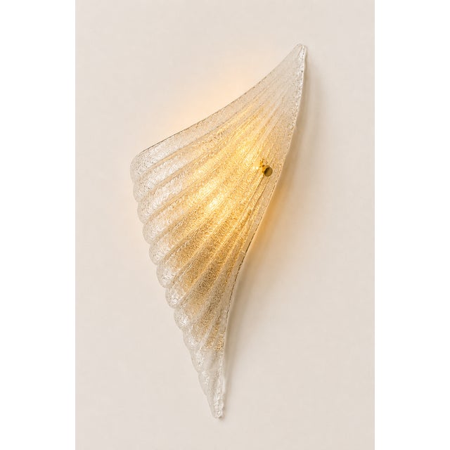 Pair of wall sconces made of pressed, molded Murano glass, produced in Italy in the 1980s. Several pairs available....