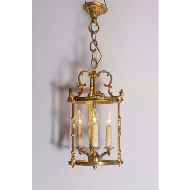 This exquisite 20th-century French lantern showcases timeless elegance and refined craftsmanship. Its gilded metal frame,...