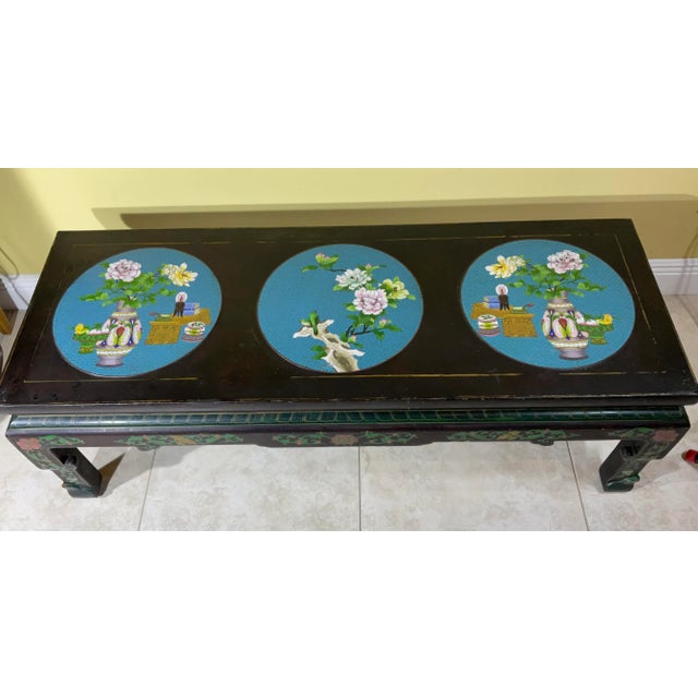 A black lacquer Chinese coffee table with three large cloisonné turquoise circles on top , depicting flowers birds and...