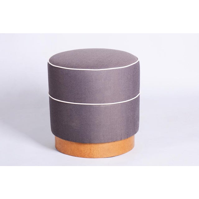This elegant round Art Deco stool comes from Czechoslovakia from the first half of the 20th century. It features new...