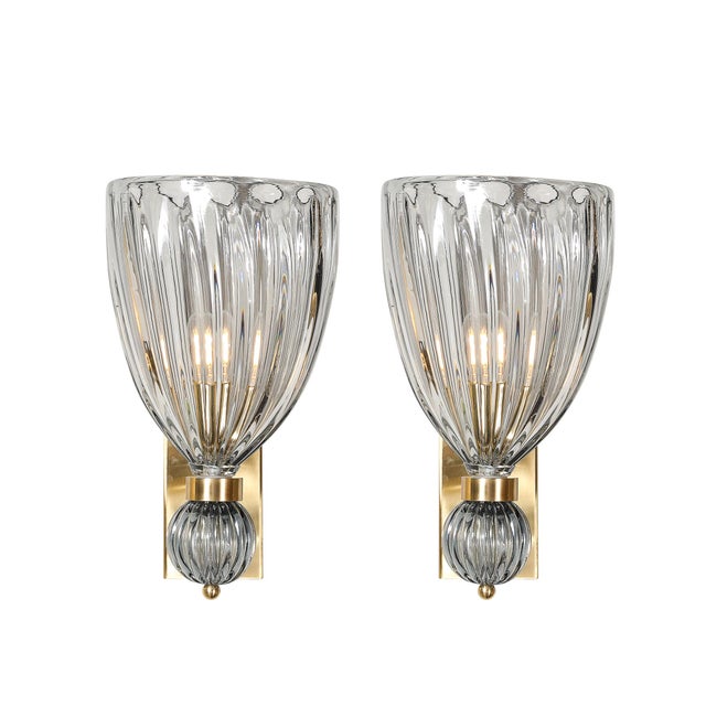 A stunning pair of modernist hand-blown Murano fluted glass sconces, featuring an orbital drop design in a sophisticated...