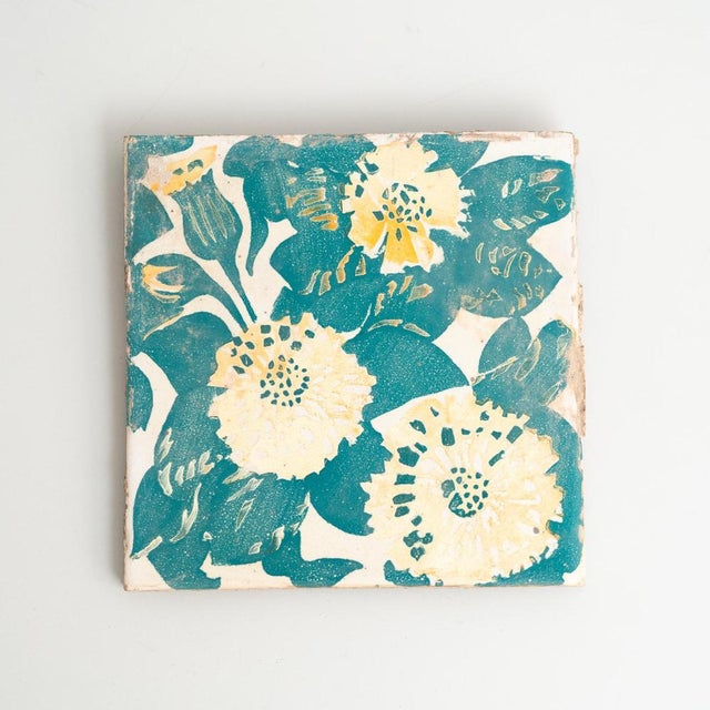 Decorative ceramic tile by Antoni Gaudi, inspired by the marigold and dianthus motifs on the decorative ceramic tiles he...