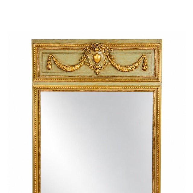 A handsome antique French pier mirror dating to the late 19th century, circa 1880–1900, distinguished by its tall...