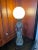 An unusual Art Deco table lamp by La Belle Specialty Company made in the 1920's. This figural lamp depicts a kneeling Joan...
