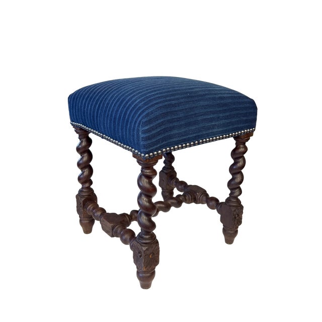 This antique French Louis XIII stool features hand-carved oak barley twist legs and a matching H-form cross stretcher....