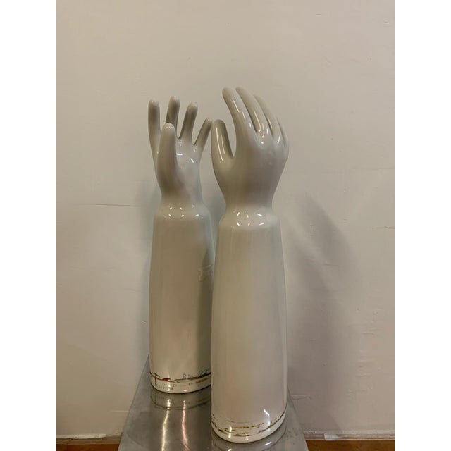 Pair of vintage porcelain glove molds. Stickers will be removed prior to sale. Approximate dimensions: 22" H x 5" Diameter