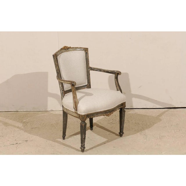 An single Italian, early 19th century accent armchair with richly carved wood details. This Italian accent chair has a...