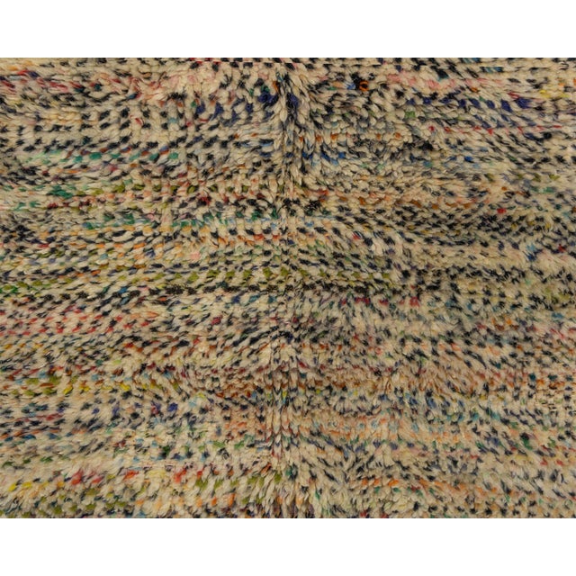 Vibrant hand-knotted wool rug featuring a bold, abstract collage of Teal, Mustard, Taupe, and Midnight Black, accented...