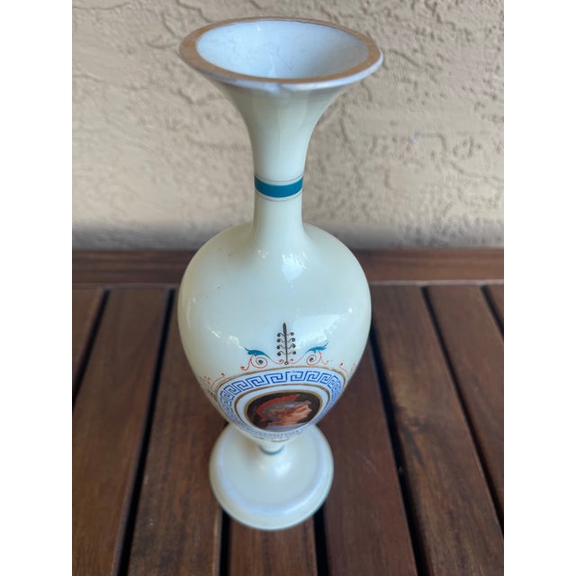 Vase in European opaline glass, milky in color. Decorated with a delicate painting of a boy's bust in reserve, flowers,...