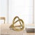 Add a touch of modern sophistication with this gold geometric knot sculpture, inspired by the elegance of the Möbius...