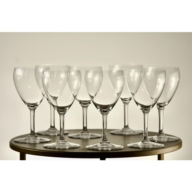 A set of eight French crystal red wine glasses by Baccarat, each signed on the underside of the foot with the acid-etched...