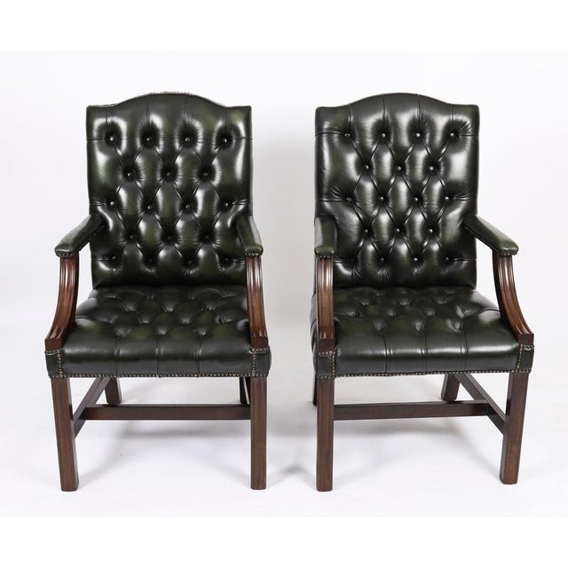 This is an elegant vintage pair of leather 'Gainsborough chairs' in a beautiful basil green colour, dating from the late...