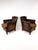 Pair of early 20th-century antique European club chairs. Original brown leather features a rich, time-earned patina with...