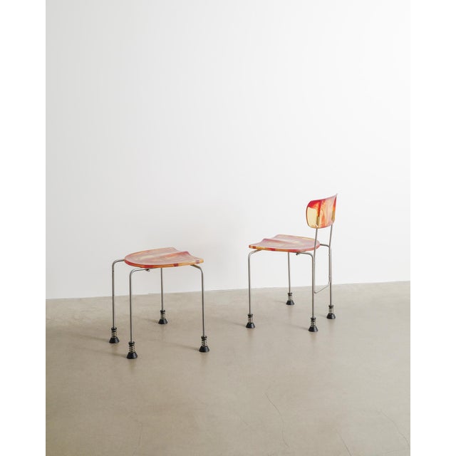 A rare contemporary "543 broadway" chair with a matching ottoman in red and yellow moulded resin seat and back, patinated...