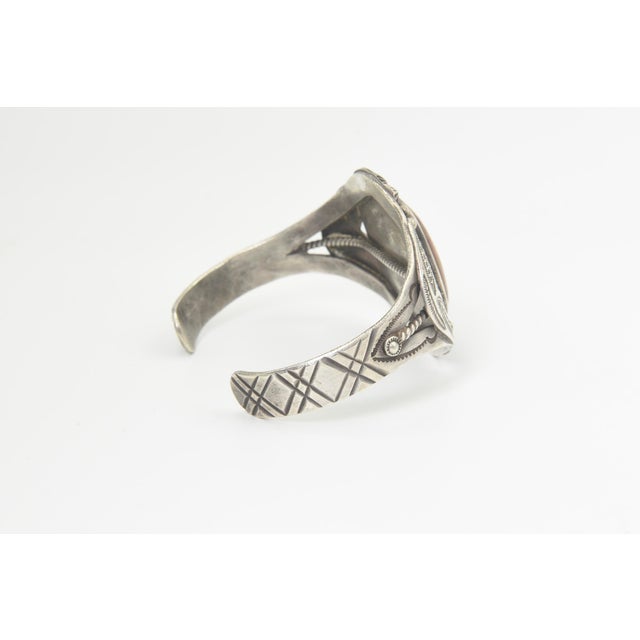 This vintage Southwestern Native American style cuff bracelet features a striking rectangular petrified wood cabochon in...