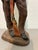 Vintage cowboy figurine statue with hand-painted finish, depicting a standing western figure holding a rifle. This rustic...