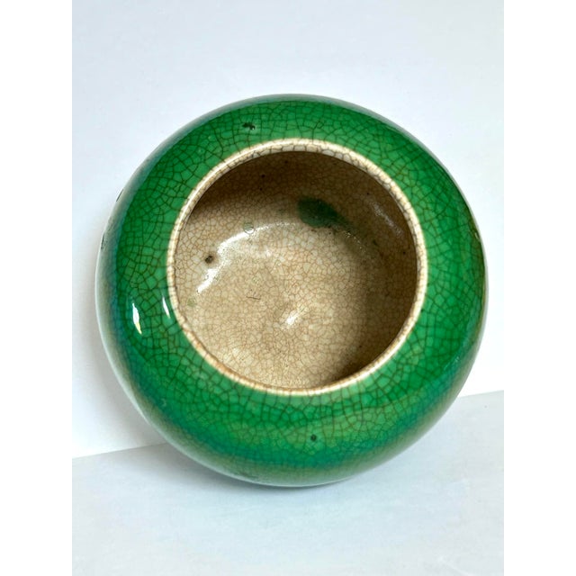 Chinese apple-green porcelain jar features a vibrant emerald crackle glaze with an extensive network of fine crazing....