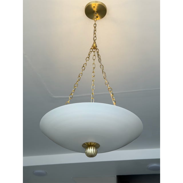Elevate your space with this elegant matte cream pendant light featuring a timeless brushed brass finish and a softly...