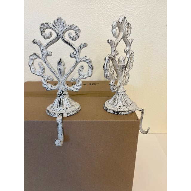 These two items are weighted cast iron mantel stocking holders designed to sit securely on a ledge or fire mantel. They...