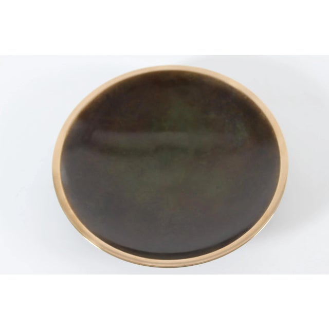 Large decorative Art Deco dish/low bowl made of bronze. Brown patinated center with golden rim. It's designed by the...