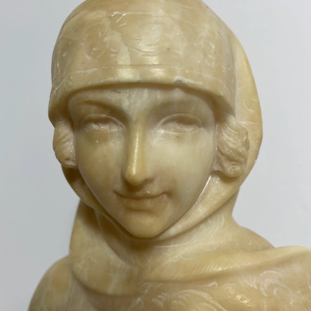 An Art Nouveau Italian Alabaster Female Bust. This sculpture is made of carved alabaster and depicts the bust of a serene...