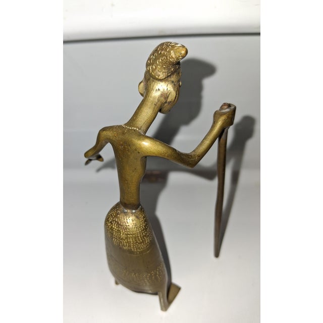 Small brass 'lost wax' figurine depicting man with walking staff. Handmade in West Africa.