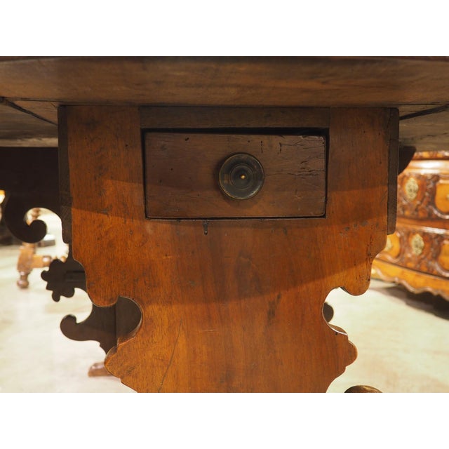 More information coming soon… A traditional Italian drop-leaf table from Tuscany, dating to the early 1800s. Beneath the...