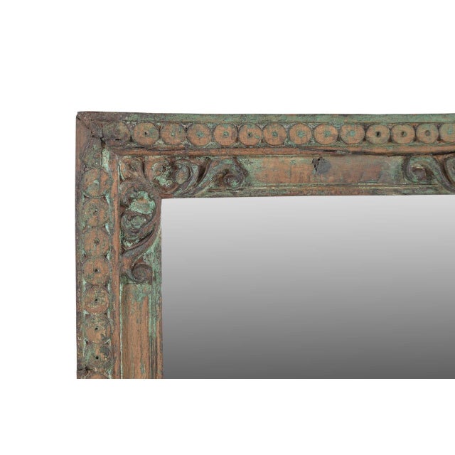 This Vintage Indian Teakwood Mirror is handcrafted from solid teakwood, featuring finely carved decorative borders...