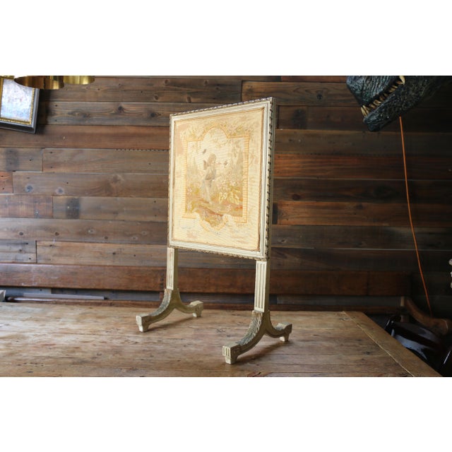 A beautiful antique French Louis XVI style firescreen featuring an elegant hand-stitched needlepoint tapestry set within a...