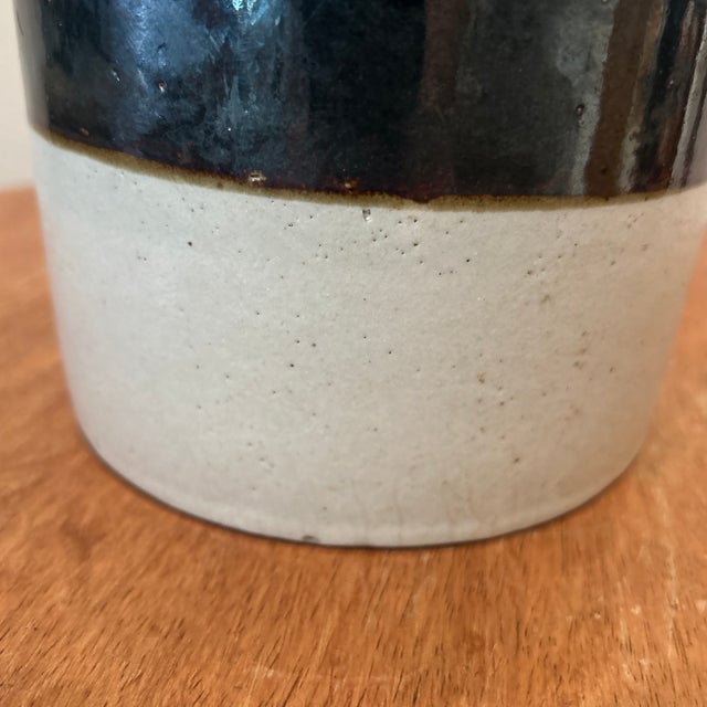 This Vintage American Primitive Two-Toned Glazed Stoneware Crock is a beautifully crafted medium-sized pot suitable for...