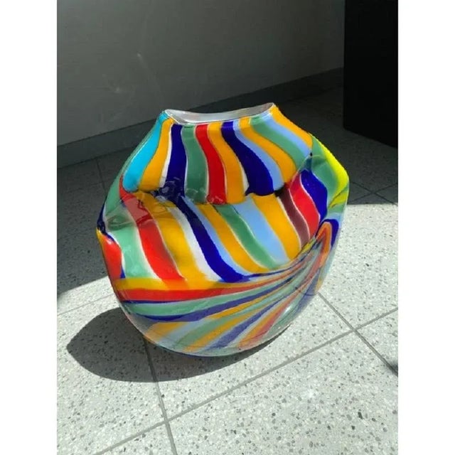 Impressive lively Vase inMurano Glass with Multicolored Reeds.The colored glass rods are melted into the milky white base...