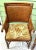 A striking pair of vintage rattan accent chairs combining warm tortoiseshell-toned bamboo, intricately woven backs, and...