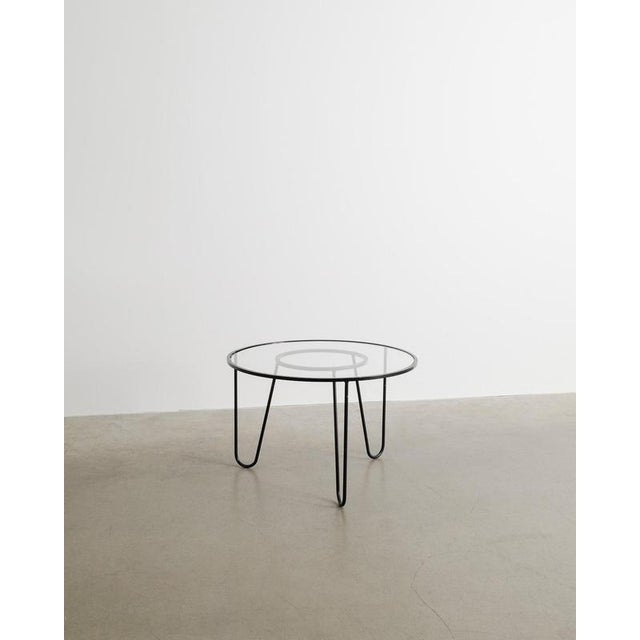 A rare round French mid century "Bellevue" side sofa table in black lacquered metal with a glass top designed by Mathieu...