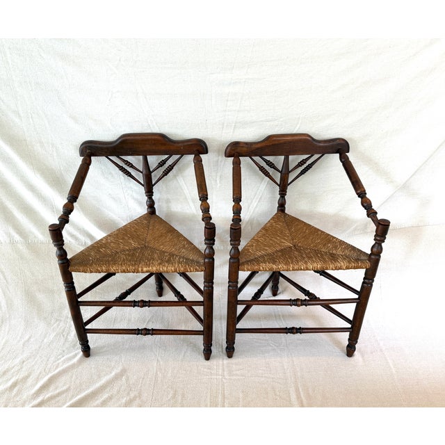 First pair I've ever found, these antique Dutch hand-crafted three-legged triangle oak chairs have a woven rush seat all...