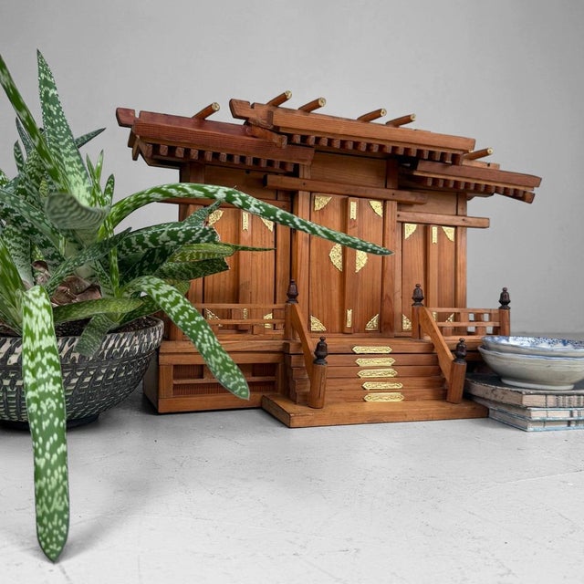 An atmospheric Japanese home shrine, a kamidana in sanja-miya form, with three separate compartments and hinged doors....