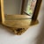 Made in Italy, this elegant Rococo Revival wall mirror features flowing gilt scrollwork and a carved cherub (putto) motif...