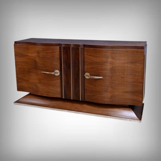 This Art Deco veneered sideboard boasts an elegant, architectural silhouette where curved lines, symmetry, and the depth...